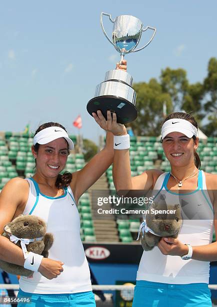 Christina McHale of the United States of America and Ajla Tomljanovic of Croatia hold aloft the championship trophy after winning their junior girls...