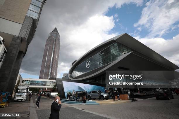 The Messe Tower skyscraper stands beyond the Daimler AG exhibition stand ahead of the IAA Frankfurt Motor Show in Frankfurt, Germany, on Monday,...