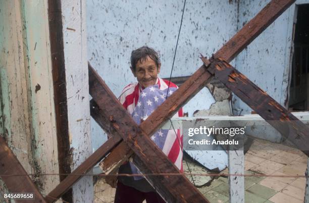 Woman smiles through broken structure in Punta Alegre, northern coast of Ciego de Avila province of Cuba after Hurricane Irma passed through the area...