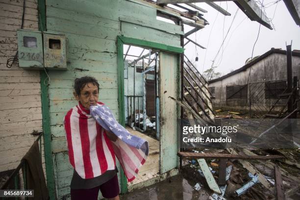 Woman covers herself with a towel in front of damaged buildings in Punta Alegre, northern coast of Ciego de Avila province of Cuba after Hurricane...