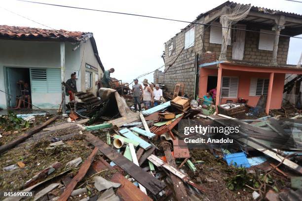 People inspect damaged buildings in Punta Alegre, northern coast of Ciego de Avila province of Cuba after Hurricane Irma passed through the area on...