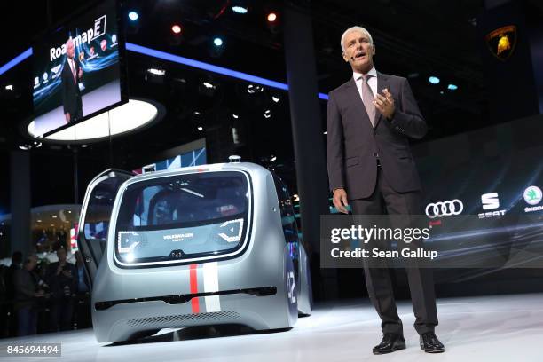 Matthias Mueller, CEO of Volkswagen, speaks while standing next to a Cedric self-driving car at the Volkswagen Preview Night prior to the 2017...