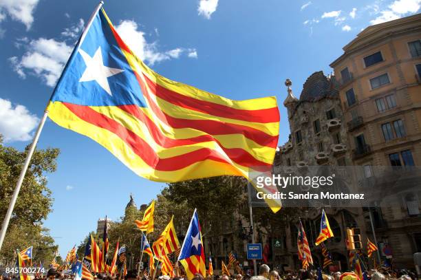People wave Esteladas as they gather during a demonstration celebrating the Catalan National Day on September 11, 2017 in Barcelona, Spain. The...