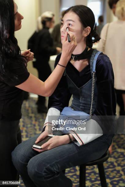 Model prepares backstage for Dennis Basso fashion show during New York Fashion Week: The Shows at The Plaza Hotel on September 11, 2017 in New York...
