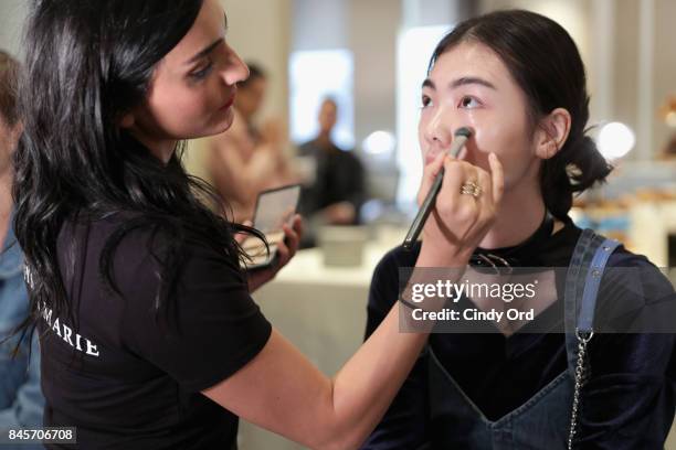 Model prepares backstage for Dennis Basso fashion show during New York Fashion Week: The Shows at The Plaza Hotel on September 11, 2017 in New York...