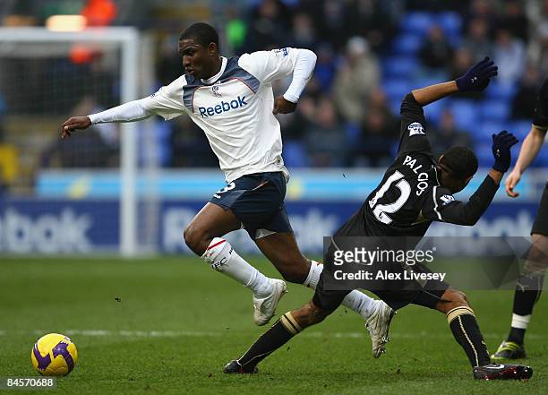 Jlloyd Samuel of Bolton Wanderers beats Wilson Palacios of Tottenham Hotspur during the Barclays Premier League match between Bolton Wanderers and...