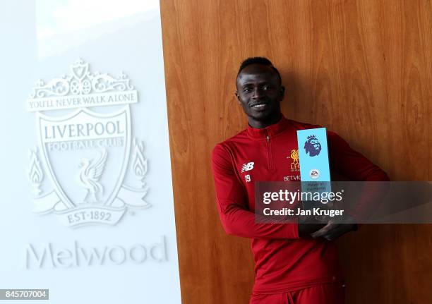 Sadio Mane of Liverpool poses with the EA SPORTS Player of the Month Award for August 2017 on September 8, 2017 in Liverpool, England.