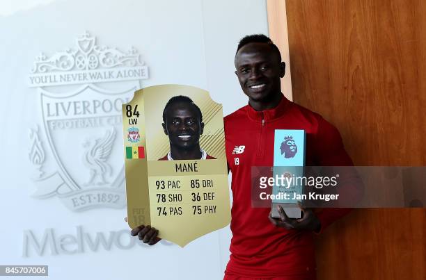 Sadio Mane of Liverpool poses with the EA SPORTS Player of the Month Award for August 2017 on September 8, 2017 in Liverpool, England.