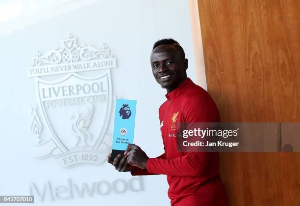 Sadio Mane of Liverpool poses with the EA SPORTS Player of the Month Award for August 2017 on September 8, 2017 in Liverpool, England.