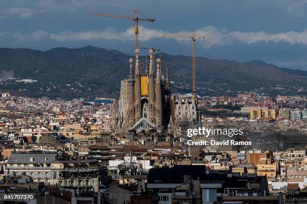 Catalan flag hangs on La Sagrada Familia during the Catalan National Day on September 11, 2017 in Barcelona, Spain. The Spanish Northeastern...