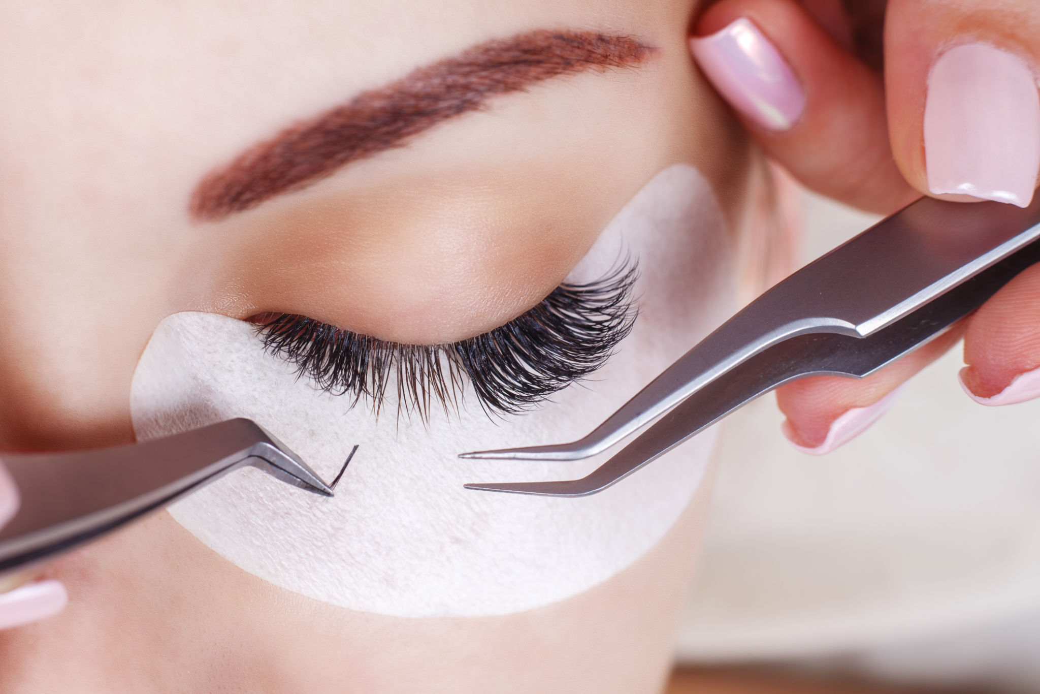 Eyelash Extension Procedure. Woman Eye with Long Eyelashes. Lashes, close up, macro, selective focus Eyelash Extension Procedure. Woman Eye with Long Eyelashes. Lashes, close up, macro, selective focus