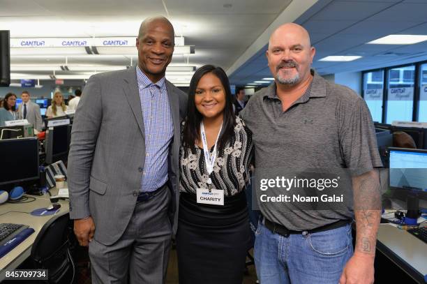 Baseball players Darryl Strawberry and David Wells pose with a guest during Annual Charity Day hosted by Cantor Fitzgerald, BGC and GFI at Cantor...