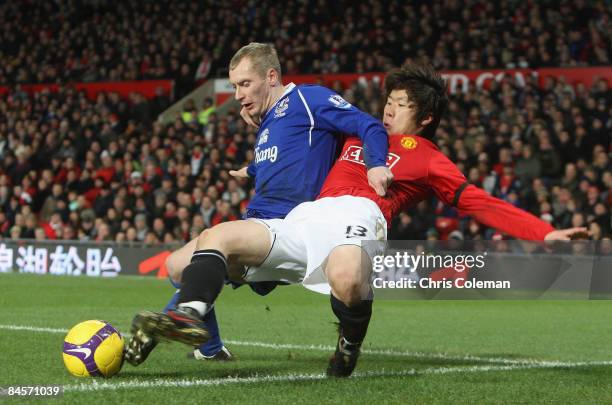 Ji-Sung Park of Manchester United clashes with Tony Hibbert of Everton during the Barclays Premier League match between Manchester United and Everton...