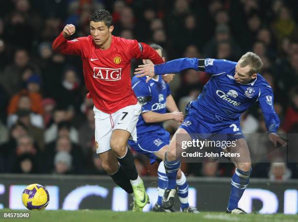 Cristiano Ronaldo of Manchester United clashes with Tony Hibbert of Everton during the Barclays Premier League match between Manchester United and...