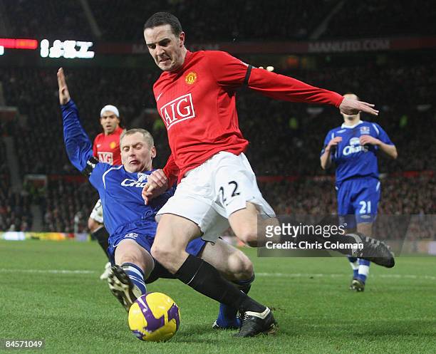 John O'Shea of Manchester United clashes with Tony Hibbert of Everton during the Barclays Premier League match between Manchester United and Everton...