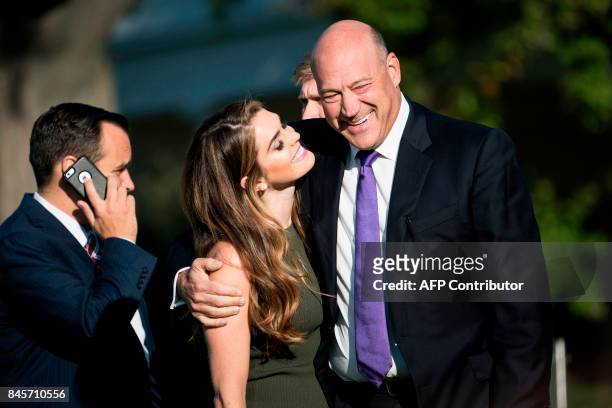 White House Communications Director Hope Hicks and National Economic Council Director Gary Cohn arrive on the South Lawn of the White House for a...