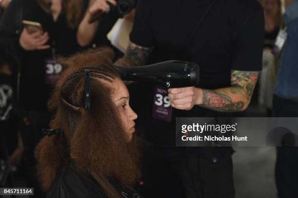 Model prepares, hair detail, backstage for Hakan Akkaya fashion show during New York Fashion Week: The Shows at Gallery 2, Skylight Clarkson Sq on...