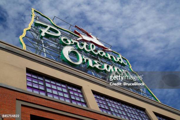 landmark stag sign on top of building in downtown portland's old town neighborhood. - portland neon sign stock pictures, royalty-free photos & images