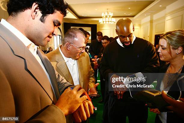 Aaron Rodgers, Tony Sparano and Donovan McNabb play with the ID Coach Wristband at the launch of the Isaac Daniel, ID Coach at the Sheraton Riverwalk...