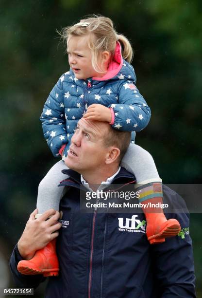 Mike Tindall carries daughter Mia Tindall on his shoulders as they attend day 3 of the Whatley Manor Horse Trials at Gatcombe Park on September 10,...