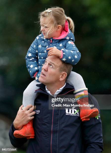 Mike Tindall carries daughter Mia Tindall on his shoulders as they attend day 3 of the Whatley Manor Horse Trials at Gatcombe Park on September 10,...