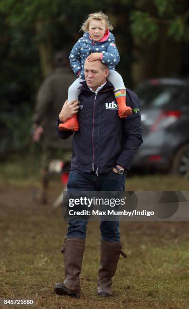 Mike Tindall carries daughter Mia Tindall on his shoulders as they attend day 3 of the Whatley Manor Horse Trials at Gatcombe Park on September 10,...