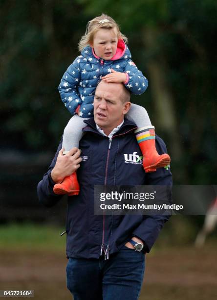 Mike Tindall carries daughter Mia Tindall on his shoulders as they attend day 3 of the Whatley Manor Horse Trials at Gatcombe Park on September 10,...