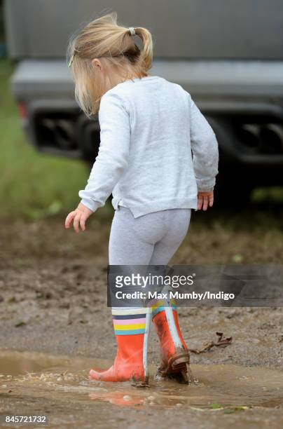 Mia Tindall splashes in a muddy puddle as she attends day 3 of the Whatley Manor Horse Trials at Gatcombe Park on September 10, 2017 in Stroud,...