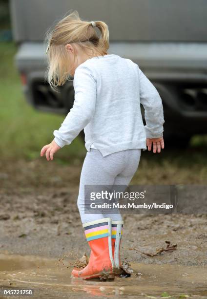 Mia Tindall splashes in a muddy puddle as she attends day 3 of the Whatley Manor Horse Trials at Gatcombe Park on September 10, 2017 in Stroud,...