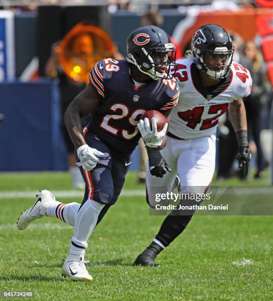 Tarik Cohen of the Chicago Bears moves past Duke Riley of the Atlanta Falcons during the season opening game at Soldier Field on September 10, 2017...