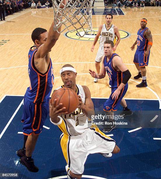 Jared Jeffries of the New York Knicks looks to block the shot of T.J. Ford of the Indiana Pacers at Conseco Fieldhouse on January 31, 2009 in...