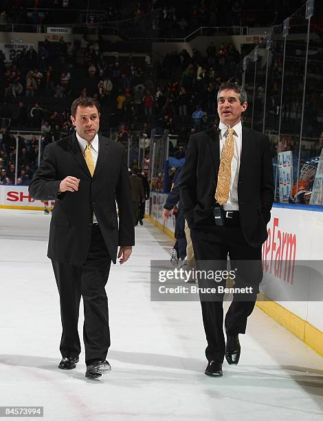 Head Coach Scott Gordon and assistant coach John Chabot of the New York Islanders leave the ice after their 3-1 win over the Florida Panthers on...