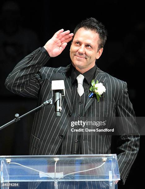 Doug Gilmour salutes the crowd as his is raised to the rafters prior to the Toronto Maple Leafs taking on the Pittsburgh Penguins during their NHL...