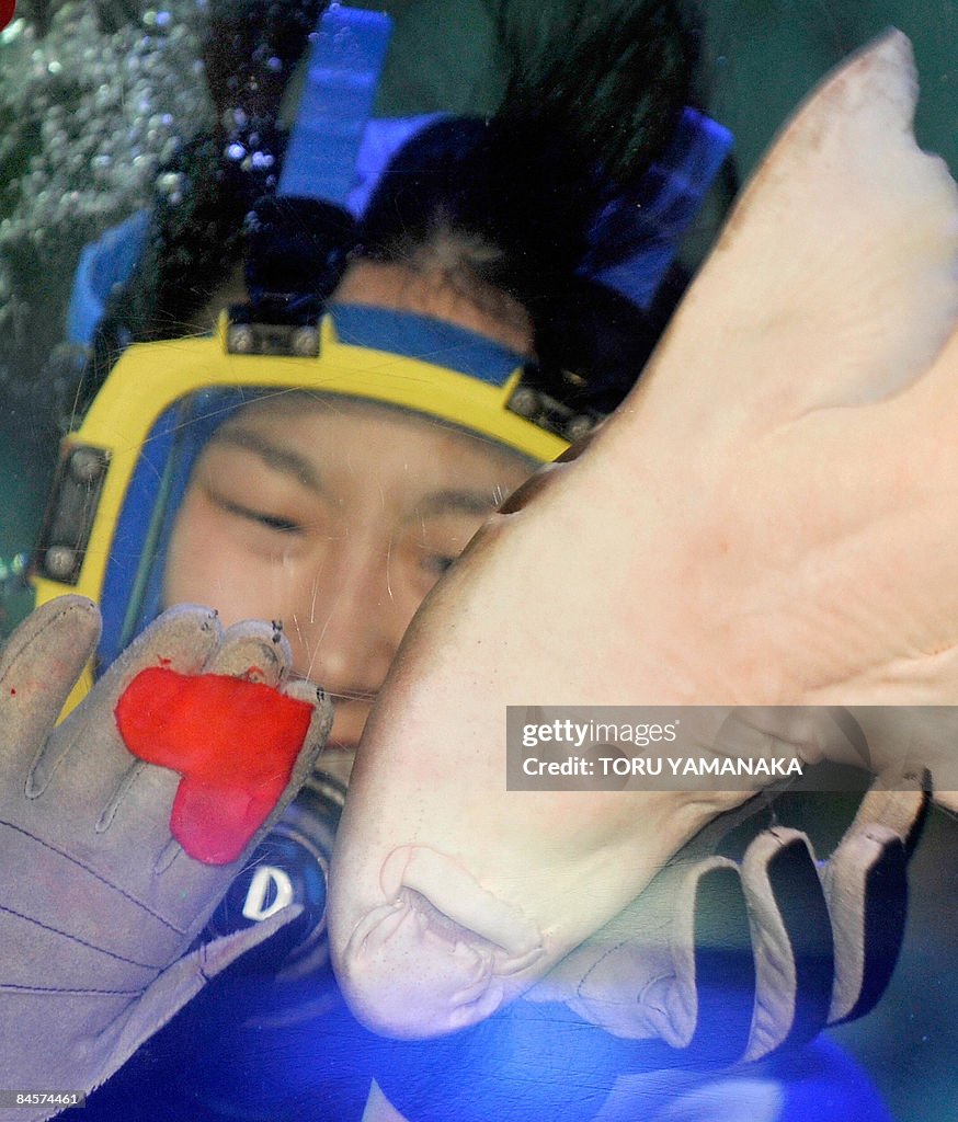 A female diver presents a red heart-shap