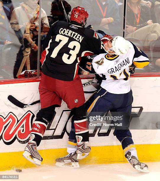 Steven Goertzen of the Phoenix Coyotes checks Marc-Andre Gragnani of the Buffalo Sabres into the boards on January 31, 2009 at Jobing.com Arena in...