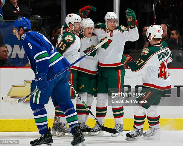 Mikko Koivu of the Minnesota Wild is congratulated by teammates Marc-Andre Bergeron, Andrew Brunette and Antti Miettinen after scoring a goal while...