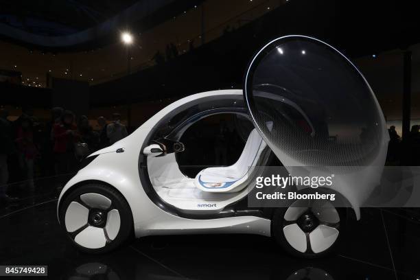Door sits open on a Daimler Smart Vision EQ fortwo electric autonomous self-driving concept automobile during the Daimler media night ahead of the...