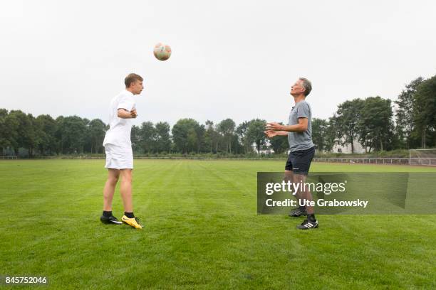 Duelmen, Germany Leisure sports, training on a sports field. A man and a teenager are practicing headballs. Staged picture on August 10, 2017 in...