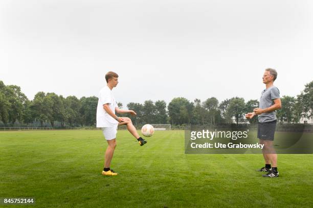 Duelmen, Germany Leisure sports, training on a sports field. A man and a teenager are practicing soccer. Staged picture on August 10, 2017 in...