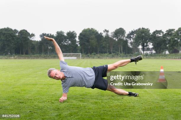 Duelmen, Germany Leisure sports, personal fitness. A man is practicing a side plank on a sports field. Staged picture on August 10, 2017 in Duelmen,...