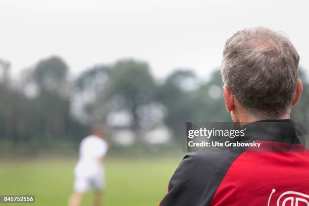 Duelmen, Germany Rear view of a coach at the edge of a playing field. Staged picture on August 10, 2017 in Duelmen, Germany.