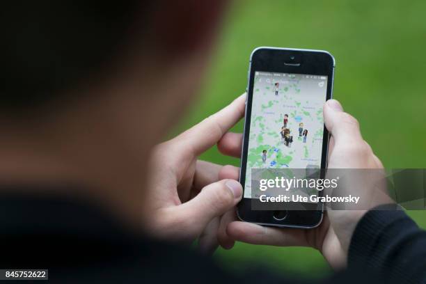 Duelmen, Germany Young man looks at a map, on which friends are marked, on Snapchat, a social media app on a smartphone. Staged picture on August 10,...