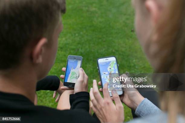 Duelmen, Germany Two youngsters are looking at maps, on which friends are marked, on Snapchat a social media app on a smartphone. Staged picture on...