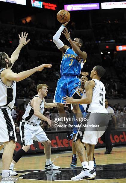 Guard Chris Paul of the New Orleans Hornets takes a shot against George Hill of the San Antonio Spurs on January 31, 2009 at AT&T Center in San...