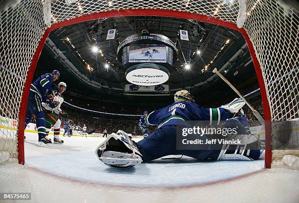 Roberto Luongo of the Vancouver Canucks loses his stick while reaching to deflect a shot during a game against the Minnesota Wild at General Motors...