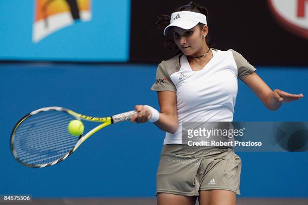 Sania Mirza of India plays a forehand in her mixed doubles final match with Mahesh Bhupathi of India against Nathalie Dechy of France and Andy Ram of...