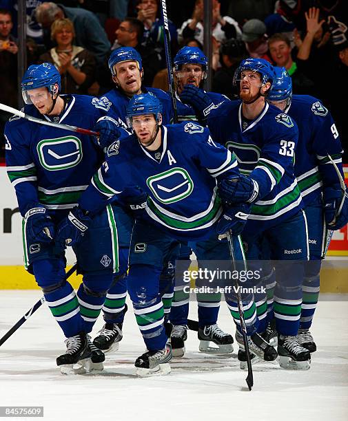 Ryan Kesler of the Vancouver Canucks celebrates his goal with teammates after scoring against the Minnesota Wild during their game at General Motors...