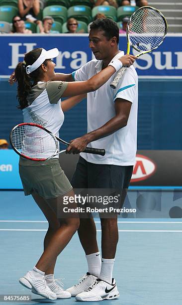 Sania Mirza and Mahesh Bhupathi of India celebrate winning championship point in their mixed doubles final match against Nathalie Dechy of France and...