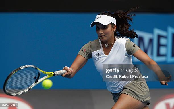 Sania Mirza of India plays a forehand in her mixed doubles final match with Mahesh Bhupathi of India against Nathalie Dechy of France and Andy Ram of...