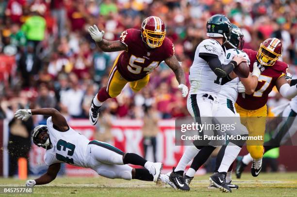 Mason Foster of the Washington Redskins flies in the air as Quarterback Carson Wentz of the Philadelphia Eagles scrambles in the second half at...